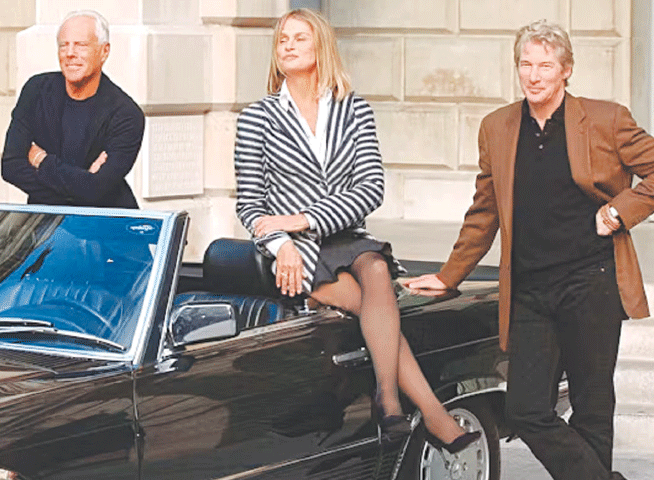 American actor Richard Gere, right, and Lauren Hutton, centre, who were both dressed in Armani clothes when they starred in the film American Gigolo, are seen with Giorgio Armani at the Royal Academy of Arts in London in 2003 | AP Photo/Richard Lewis