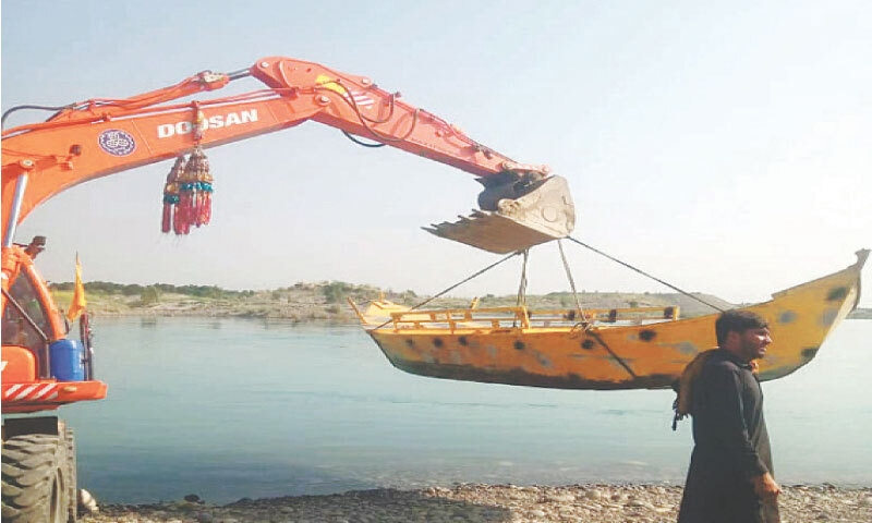 A boat is being lifted with the help of a crane on the bank of Indus River in Attock Khurd on Friday. The Attock district administration is dispatching boats to the flood affected areas of South Punjab to carry out relief and rescue operations. &mdash; Dawn