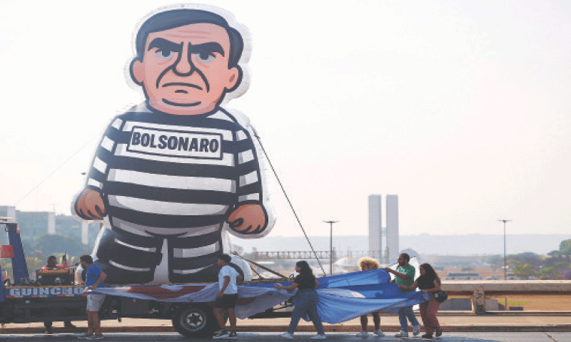 BRASILIA: An inflatable figure, depicting Jair Bolsonaro, is erected by protesters.&mdash;Reuters