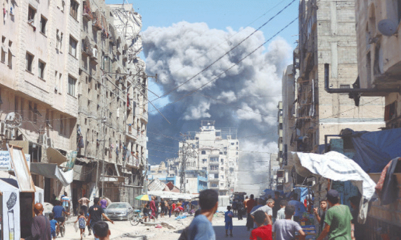 GAZA CITY: A massive cloud of smoke rises after an Israeli strike on Al-Nassr Street. Israel&rsquo;s military dropped leaflets asking residents to leave as it stepped up a deadly assault on the Palestinian territory.&mdash;AFP