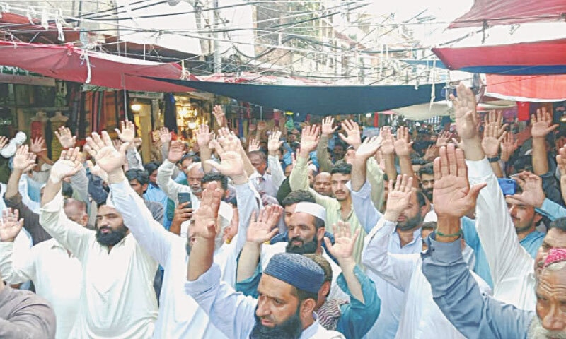 Traders raise slogans during their protest in Gujar Khan on Saturday. — Dawn Traders raise slogans during their protest in Gujar Khan on Saturday. — Dawn