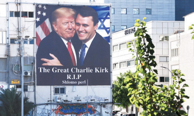 Tel Aviv: A billboard showing an image of President Donald Trump embracing US right-wing activist Charlie Kirk hangs on the side of a building in the Israeli capital.&mdash;AFP