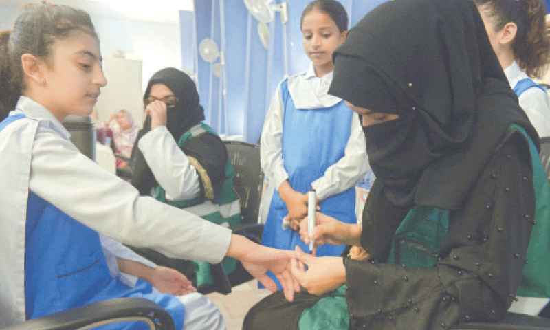 A girl is marked with indelible ink on her finger after receiving the HPV vaccine against cervical cancer at Islamabad College for Girls F-6/2 on Monday under a campaign that will continue until September 27. &mdash; Photo by Mohammad Asim