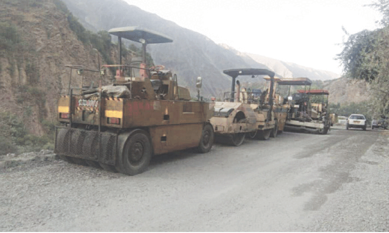 Road building machinery lies idle on Chitral-Shandur Road near Mori Lasht village, Chitral. &mdash; Dawn