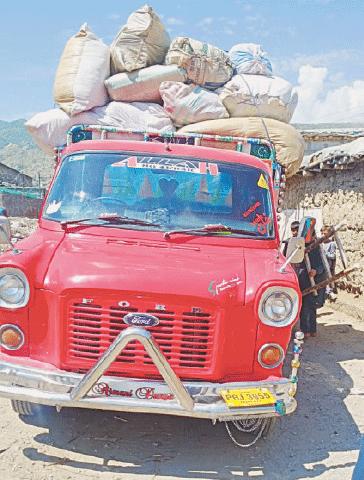A delivery vehicle loaded with belongings of returning Afghan refugees in Chakdara, Lower Dir. — Dawn