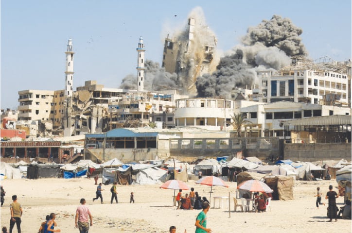Smoke rises from the evacuated Al Ghefari tower, as it collapses after it was hit by Israeli air strikes in Gaza City&mdash;Reuters