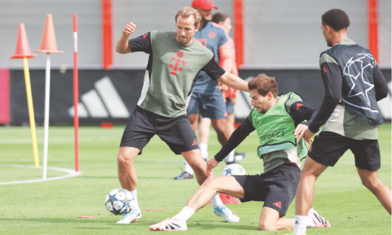 MUNICH: Bayern Munich&rsquo;s Harry Kane (L) and Leon Goretzka vie for the ball during a training session on Tuesday.&mdash;AFP