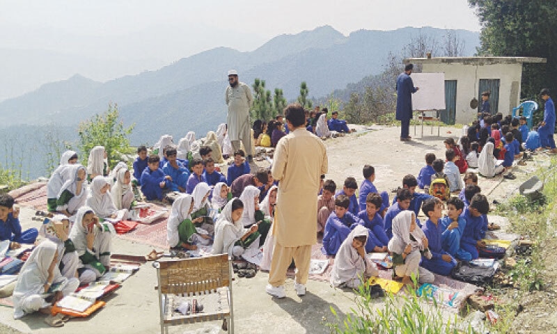 Students of a government primary school in Koheri Bala area of Lower Dir attend classes under the open sky due to unavailability of building. &mdash; Dawn