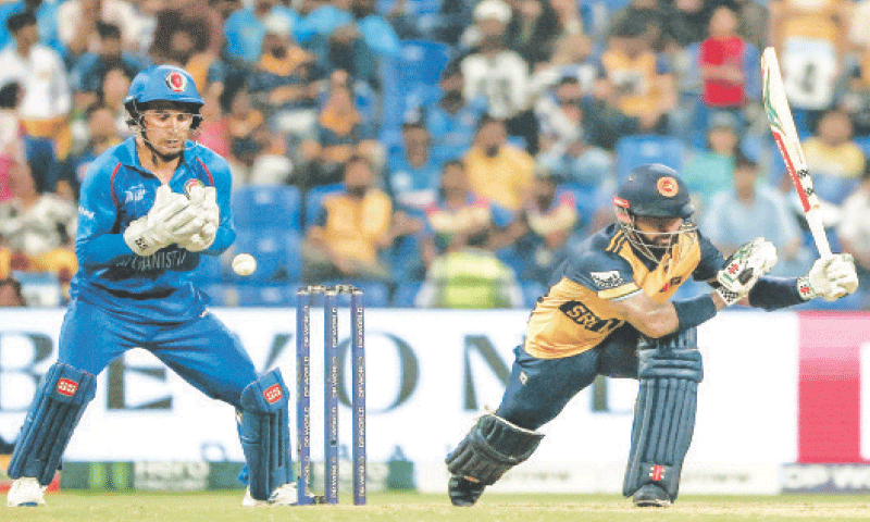 SRI LANKAN opener Kusal Mendis plays a shot as Afghanistan wicket-keeper Rahmanullah Gurbaz looks on during the Asia Cup match at the Sheikh Zayed Cricket Stadium on Thursday.&mdash;AFP