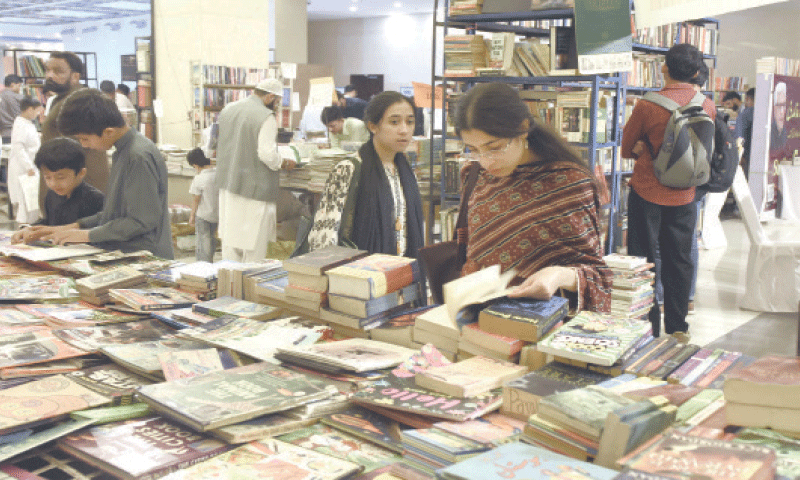 Visitors go through books during the international book fair at Pak-China Friendship Centre in Islamabad on Friday. &mdash; Photo by Tanveer Shahzad