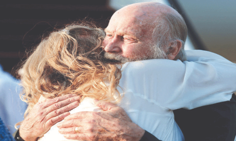 Peter Reynolds is being greeted by his daughter after he arrived in Doha, Qatar, from Kabul.&shy;&mdash;Reuters
