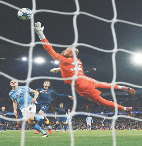 MANCHESTER: Manchester City’s Erling Haaland (L) heads to score during the Champions League match against Napoli at the Etihad Stadium.—Reuters