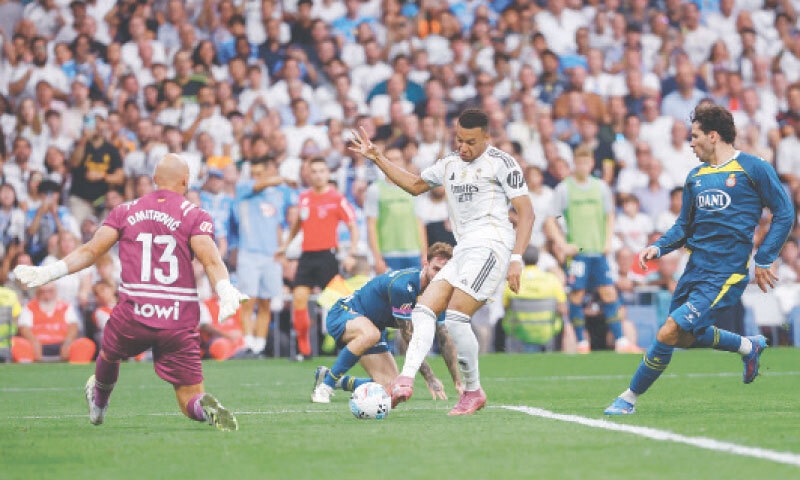 MADRID: Real Madrid&rsquo;s Kylian Mbappe (C) shoots but fails to score past Espanyol goalkeeper Marko Dmitrovic (L) during their La Liga match at Santiago Bernabeu.&mdash;AFP