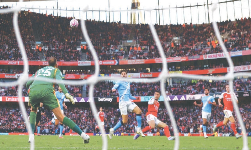 LONDON: Arsenal&rsquo;s Gabriel Martinelli (third R) scores past Manchester City goalkeeper Gianluigi Donnarumma during their Premier League match at the Emirates Stadium on Sunday.&mdash;Reuters