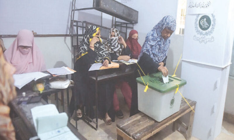 A voter casts their ballot in a UC-1 polling station of Gulshan-i-Bihar during the local government by-elections in Orangi Town.&mdash;Fahim Siddiqi / White Star