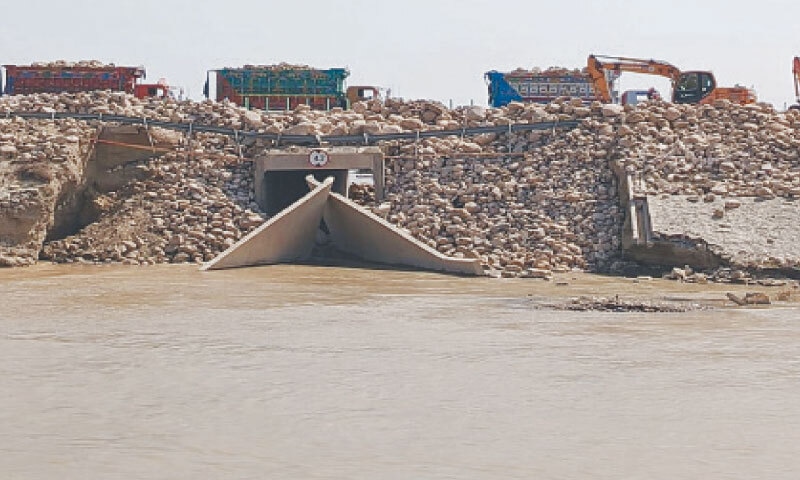  HEAVY machinery is used to fill a breach in the M5 motorway near Jalalpur Pirwala. Locals complain that efforts to save the motorway have drowned their villages instead.—Dawn 