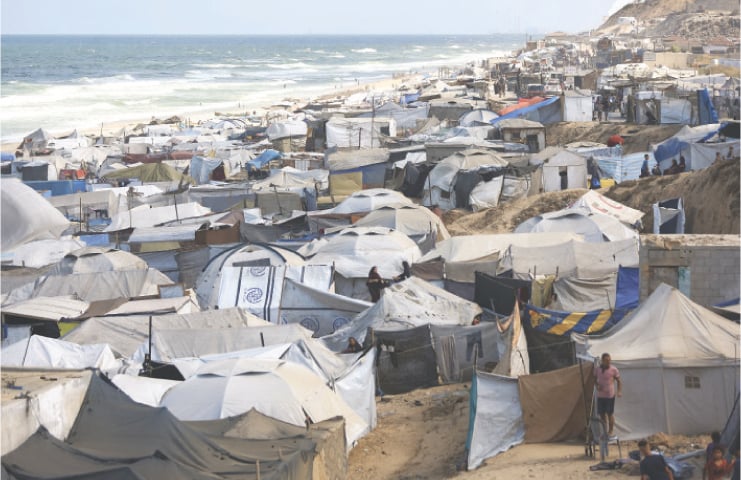 PALESTINIANS displaced by Israeli bombardment take shelter in a tent camp in Zawaida, a town in central
Gaza Strip.—Reuters