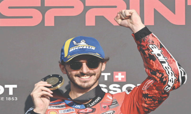 MOTEGI: Ducati’s Italian rider Francesco Bagnaia celebrates on the podium after winning the sprint race of the Japanese MotoGP at the Mobility Resort Motegi on Saturday.—AFP MOTEGI: Ducati’s Italian rider Francesco Bagnaia celebrates on the podium after winning the sprint race of the Japanese MotoGP at the Mobility Resort Motegi on Saturday.—AFP