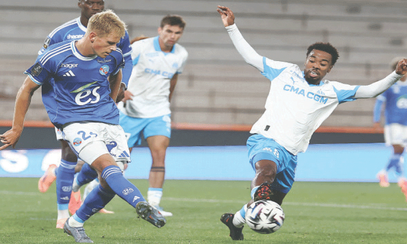 STRASBOURG: Olympique de Marseille’s Angel Gomes (R) vies for the ball with Lucas Hogsberg of Strasbourg during their Ligue 1 match at the Stade de la Meinau.—AFP STRASBOURG: Olympique de Marseille’s Angel Gomes (R) vies for the ball with Lucas Hogsberg of Strasbourg during their Ligue 1 match at the Stade de la Meinau.—AFP