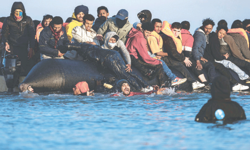 MIGRANTS try to board smugglers&rsquo; boats in an attempt to cross the English Channel off Gravelines,
northern France. &mdash; AFP