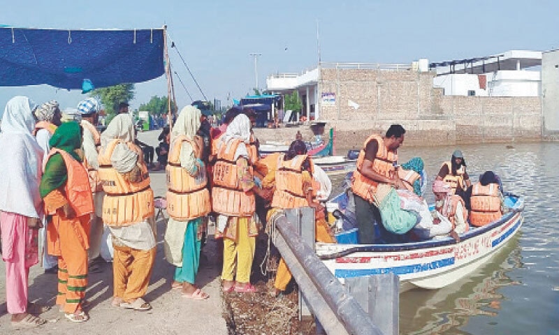 Rescue officials moving flood-hit people to safety near Multan.—PPI