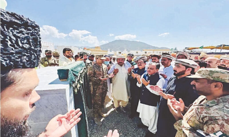 Officials pray at the opening ceremony of border in Lower South Waziristan on Tuesday. &mdash; Dawn
