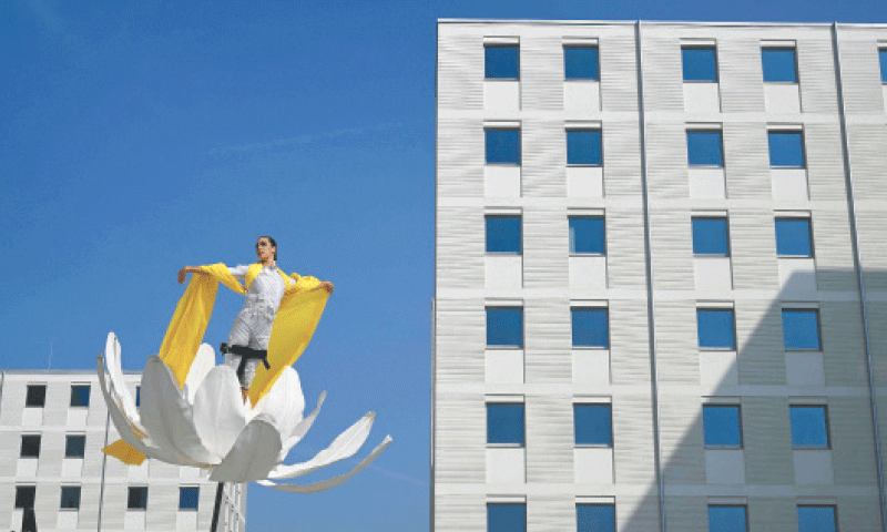 MILAN: An artist performs in the Olympic and Paralympic Village of the Milano-Cortina Winter Olympic Games 2026 on Tuesday.&mdash;AFP