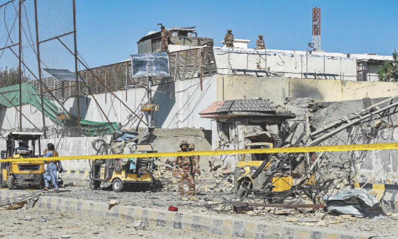QUETTA: Security personnel inspect the site of a suicide attack, outside the headquarters of the Frontier Corps. However, security forces managed to repel a subsequent attempt to infiltrate the installation.&mdash;AFP