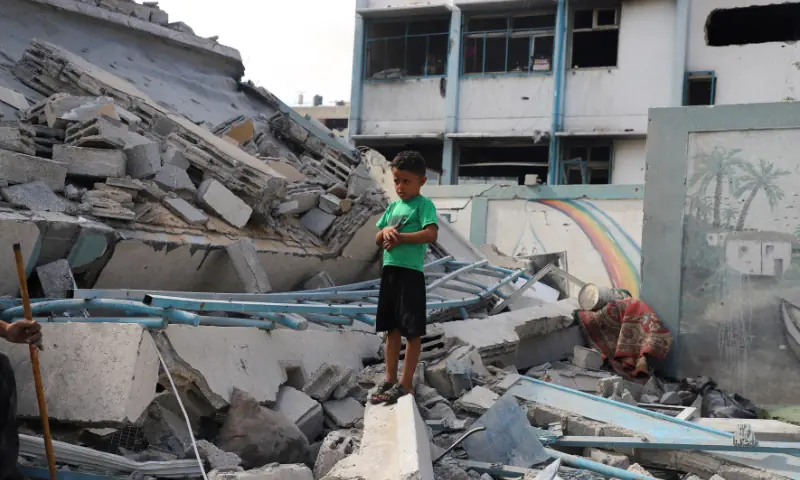 A Palestinian boy stands amid rubble at a United Nations school where displaced people were taking shelter, after it was hit in overnight Israeli strikes, amid an Israeli military operation, at Zeitoun neighbourhood in Gaza City, on October 1. — Reuters