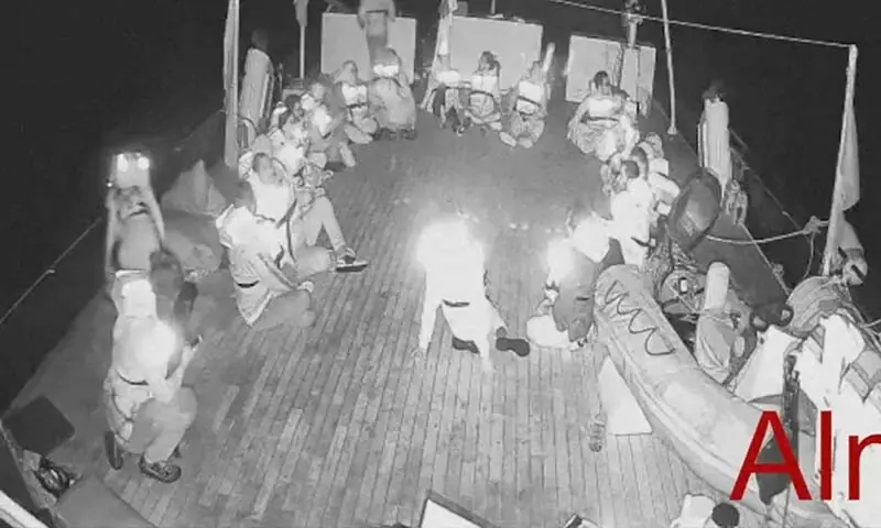 A screengrab from live video footage shows crew members sitting in a circle aboard the Gaza-bound Alma vessel, part of the Global Sumud Flotilla, in this screengrab from a video released on October 1. — Reuters