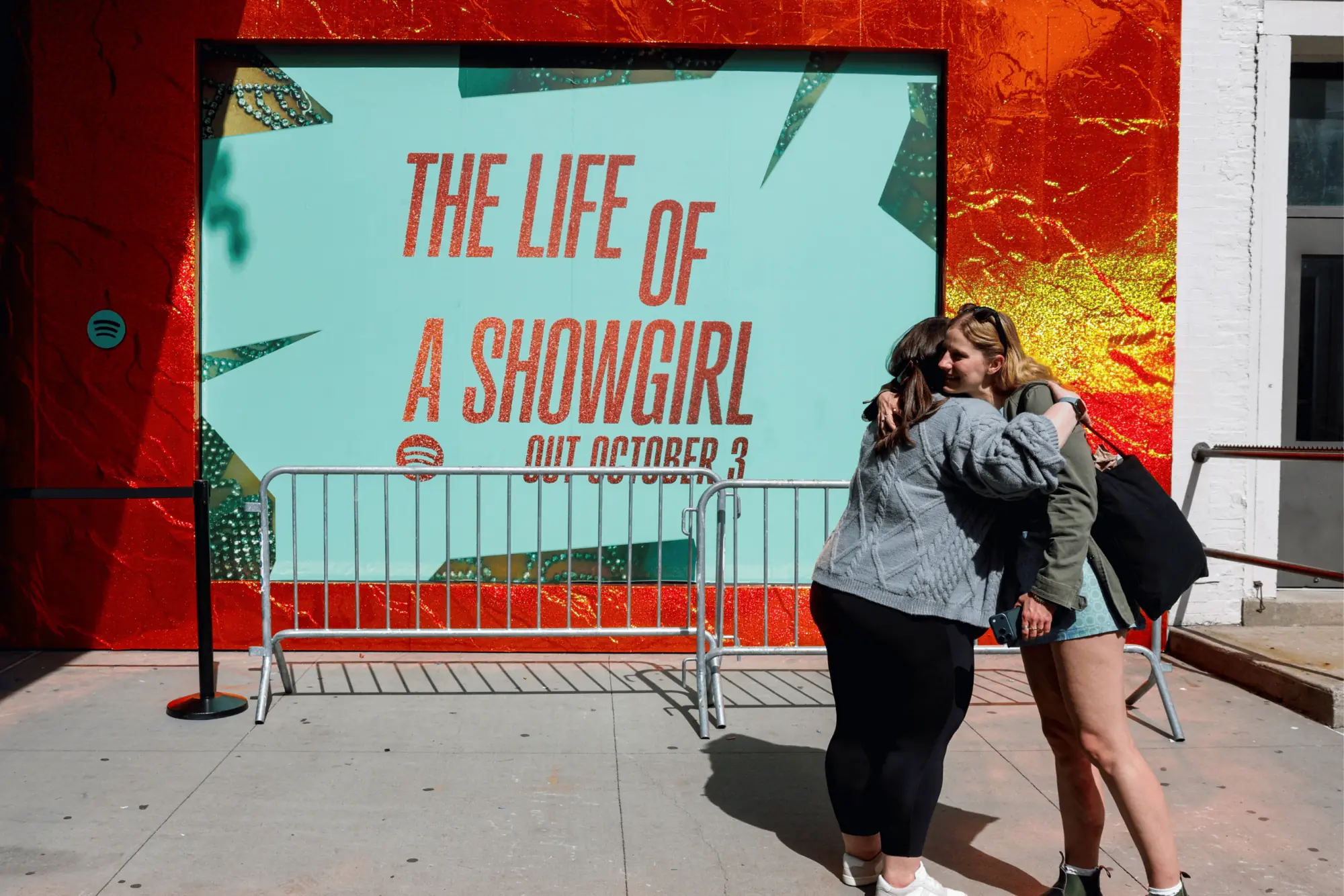 People hug outside a Spotify pop-up event for Taylor Swift&rsquo;s album <em>The Life of a Showgirl</em> in New York City. Photo: Reuters.