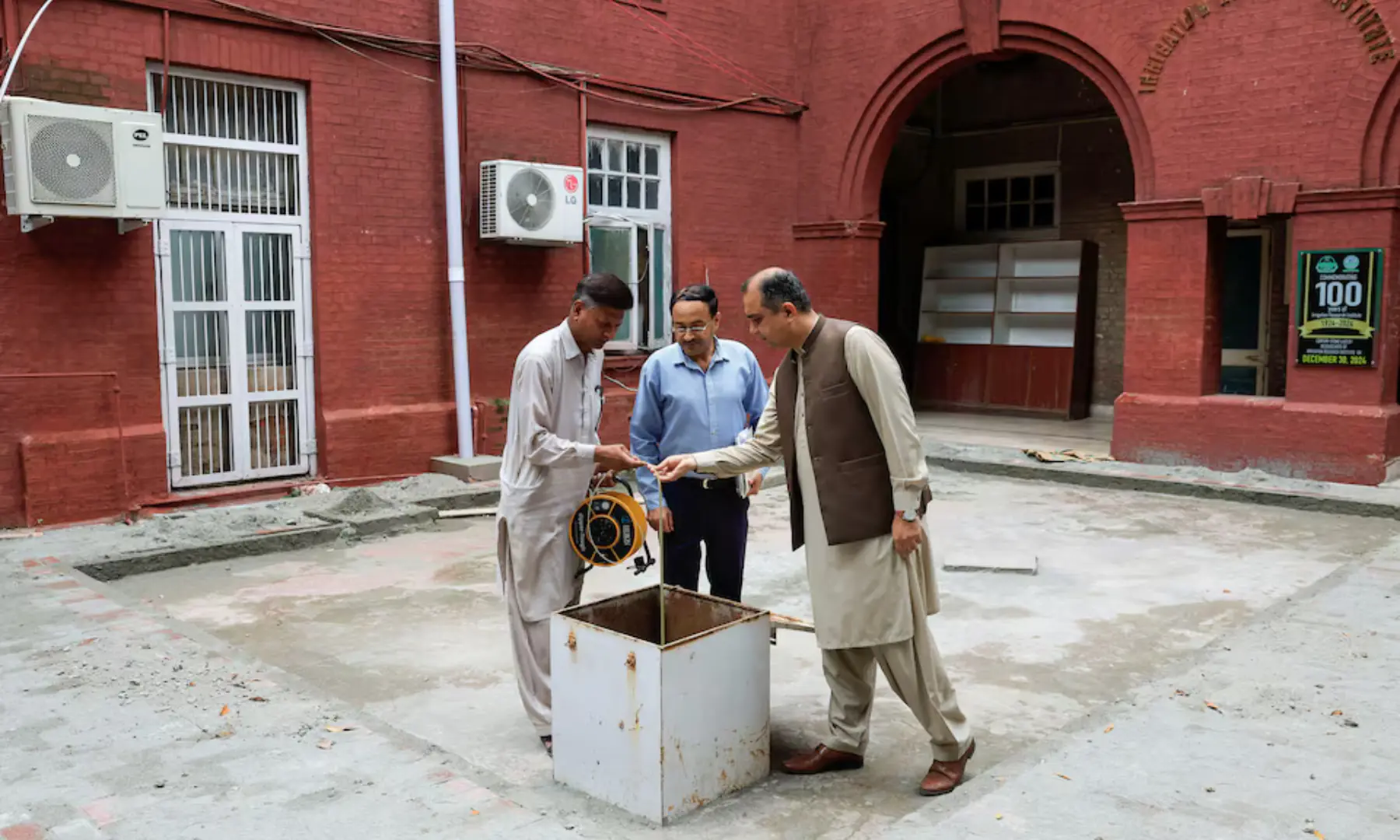 Adnan Hassan, Senior Research Officer, checks the dipmeter to examine the ground-water level from a borehole, at the Irrigation Research Institute in Punjab Irrigation Department, in Lahore, Pakistan, on August 13. &mdash; Reuters