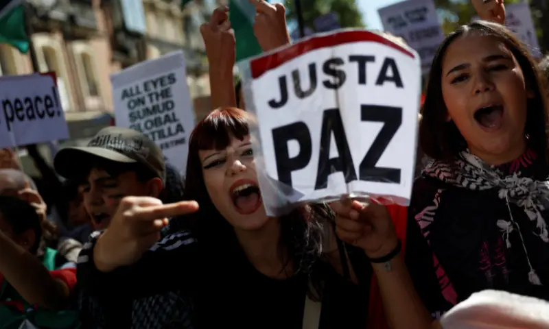 A demonstrator holds a sign that reads &ldquo;Just peace&rdquo;, as students march during a student strike to support Palestinians in Gaza and to condemn the Israeli force&rsquo;s interception of some of the vessels of the Global Sumud Flotilla, in Madrid, Spain, on October 2. &mdash; Reuters