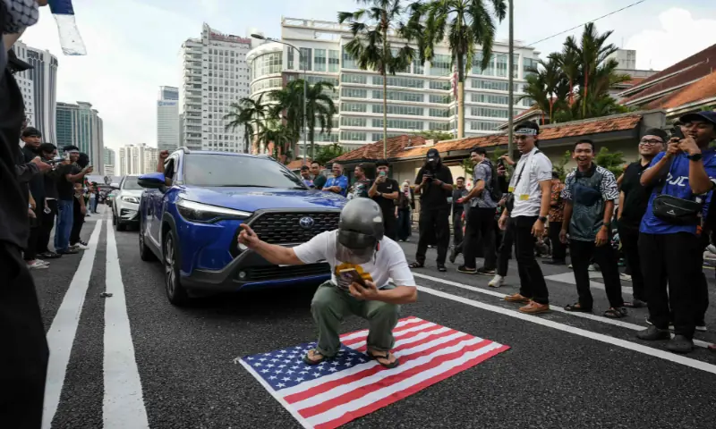A man steps on the US flag outside the US embassy to protest against Israel&rsquo;s interception of a Gaza-bound aid flotilla and the detention of at least 12 Malaysian activists, in Kuala Lumpur, Malaysia, on October 2. &mdash; AFP