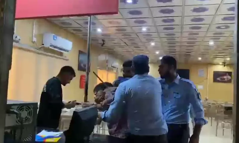 Islamabad police assault a man during a raid at the National Press Club in Islamabad on October 2. — DawnNewsTV