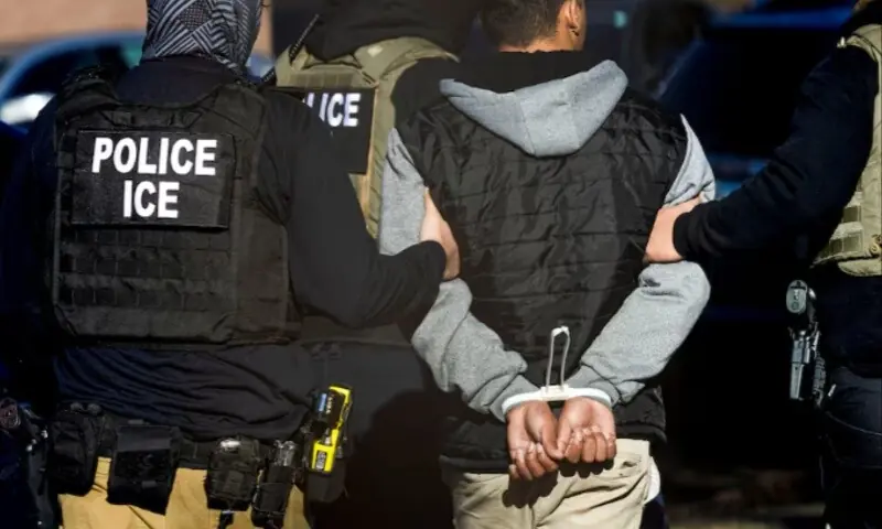 Immigration and Customs Enforcement agents detain a man after conducting a raid at the Cedar Run apartment complex in Denver, Colorado, US, February 5, 2025. &mdash; Reuters/Kevin Mohatt