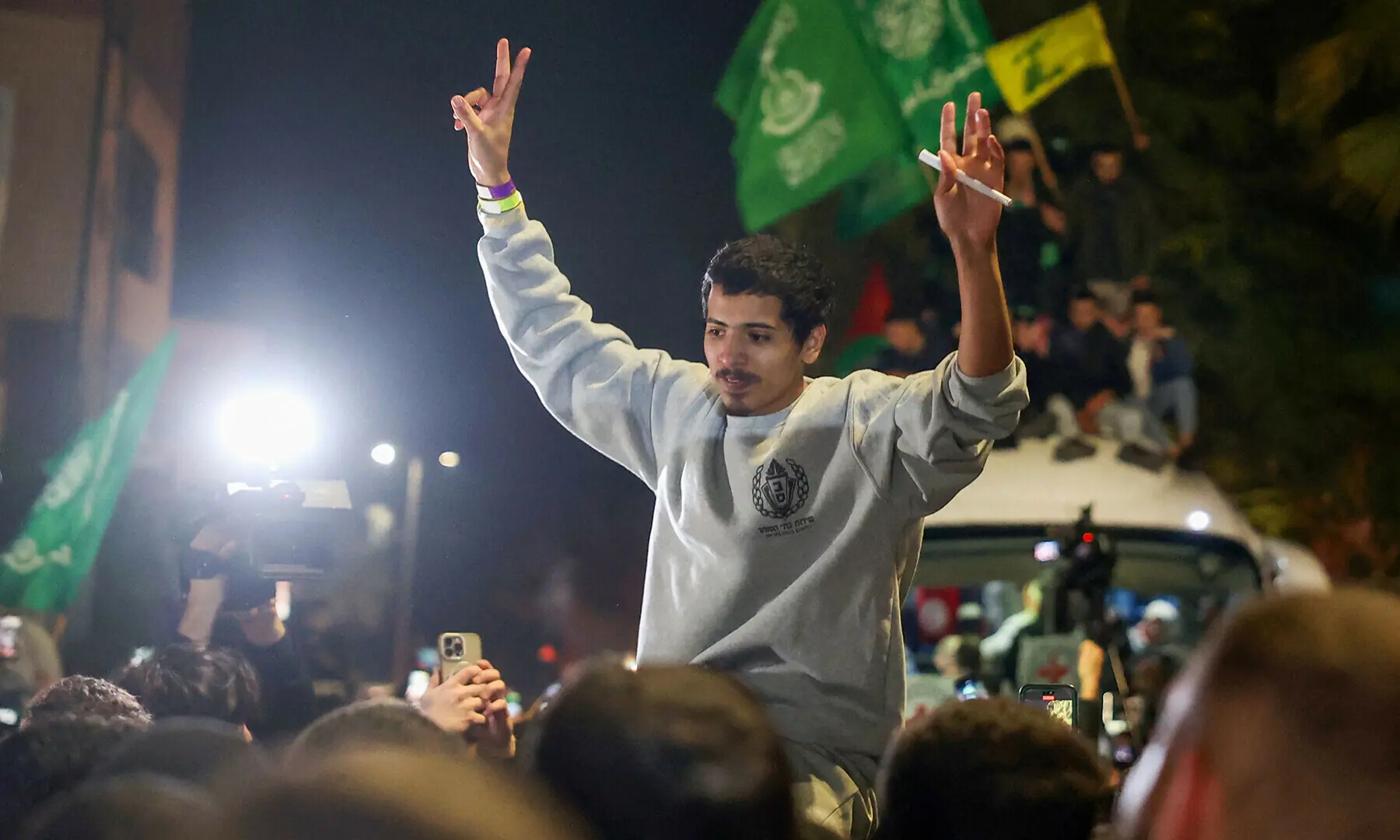 A Palestinian prisoner flashes the V-sign for victory upon his arrival in the occupied West Bank town of Beitunia, on the outskirts of Ramallah, following his release from an Israeli jail in the early hours of January 20, 2025. Crowds cheered, chanted and honked car horns as two buses carrying some 90 prisoners arrived in Beitunia following their release as part of the Gaza ceasefire deal that began on January 19 and saw three Israeli hostages freed by Hamas in the Gaza Strip. — AFP/ File