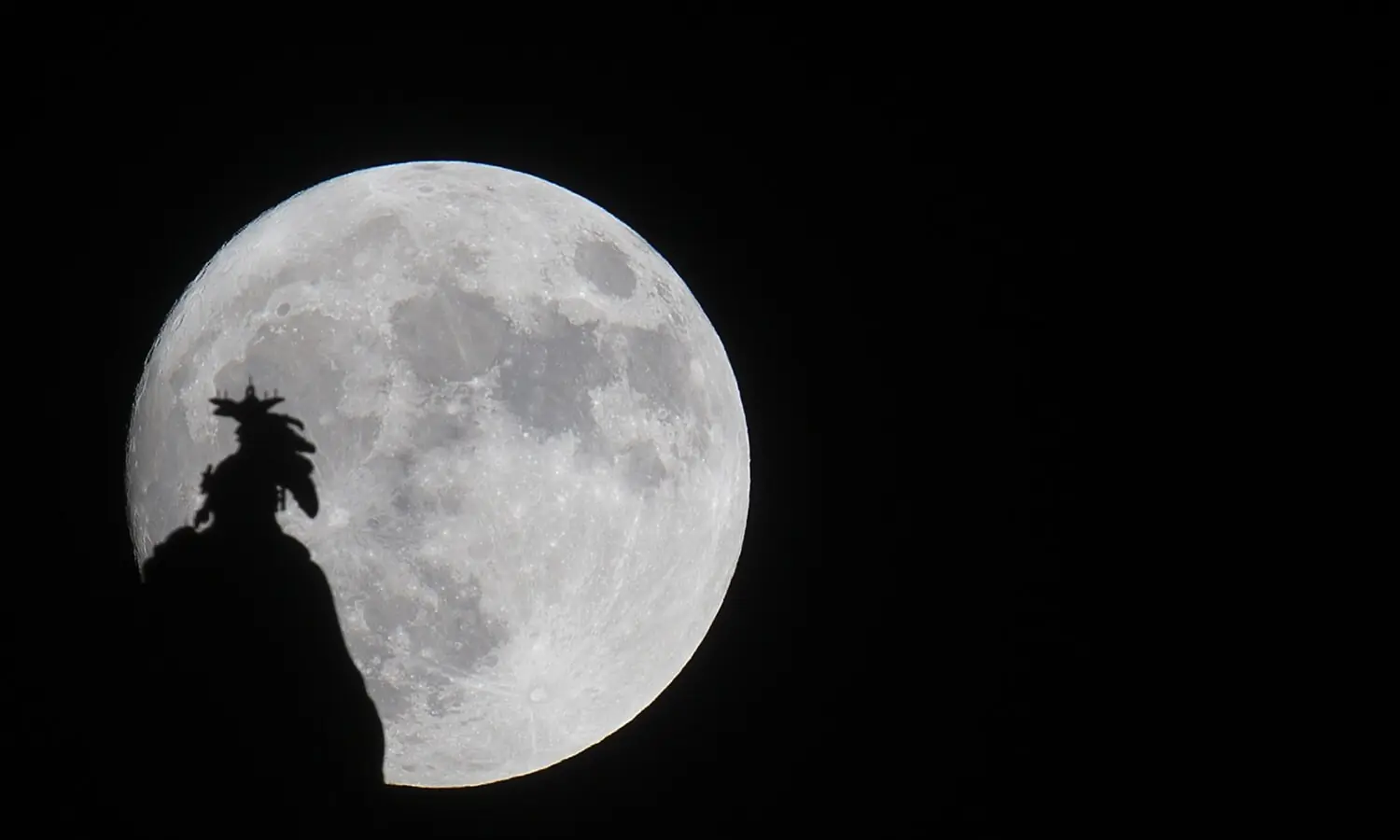 A supermoon rises over the Statue of Freedom on the Capitol dome in Washington, DC November 13, 2016. — AFP/File