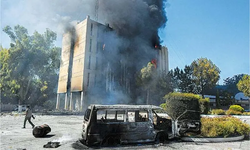 Black smoke billows from the Radio Pakistan building set ablaze by the PTI activists on May 10, 2023 in Peshawar.&mdash;AFP/File