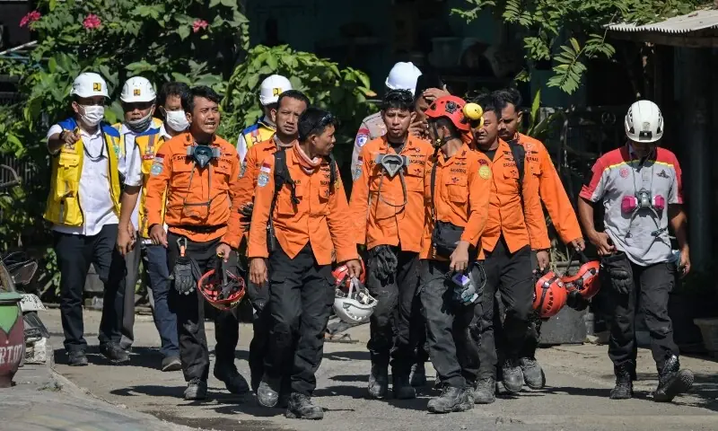 Recovery efforts continues as rescue team members walk out from the site of the collapsed Al Khoziny Islamic boarding school in Sidoarjo, East Java, Indonesia, October 6. &mdash; AFP