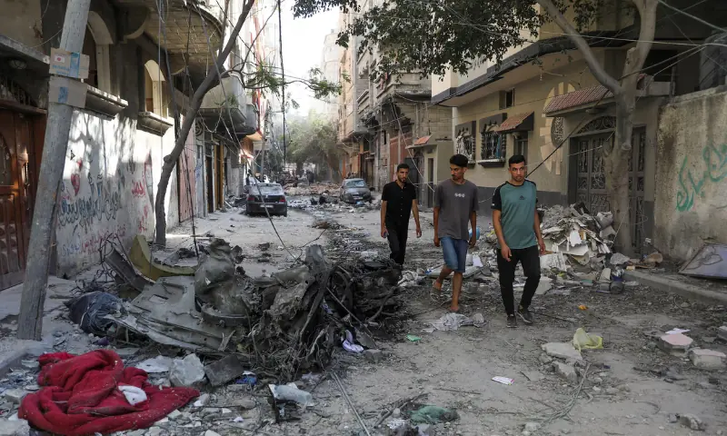 Men walk among debris, aftermath of Israeli strikes at the area, where Israeli hostages were rescued in Nuseirat refugee camp in the central Gaza Strip, on June 9, 2024. — Reuters