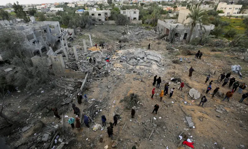 Palestinians inspect the site of an Israeli strike on a house, in Khan Younis in the southern Gaza Strip, on March 20, 2025. — Reuters