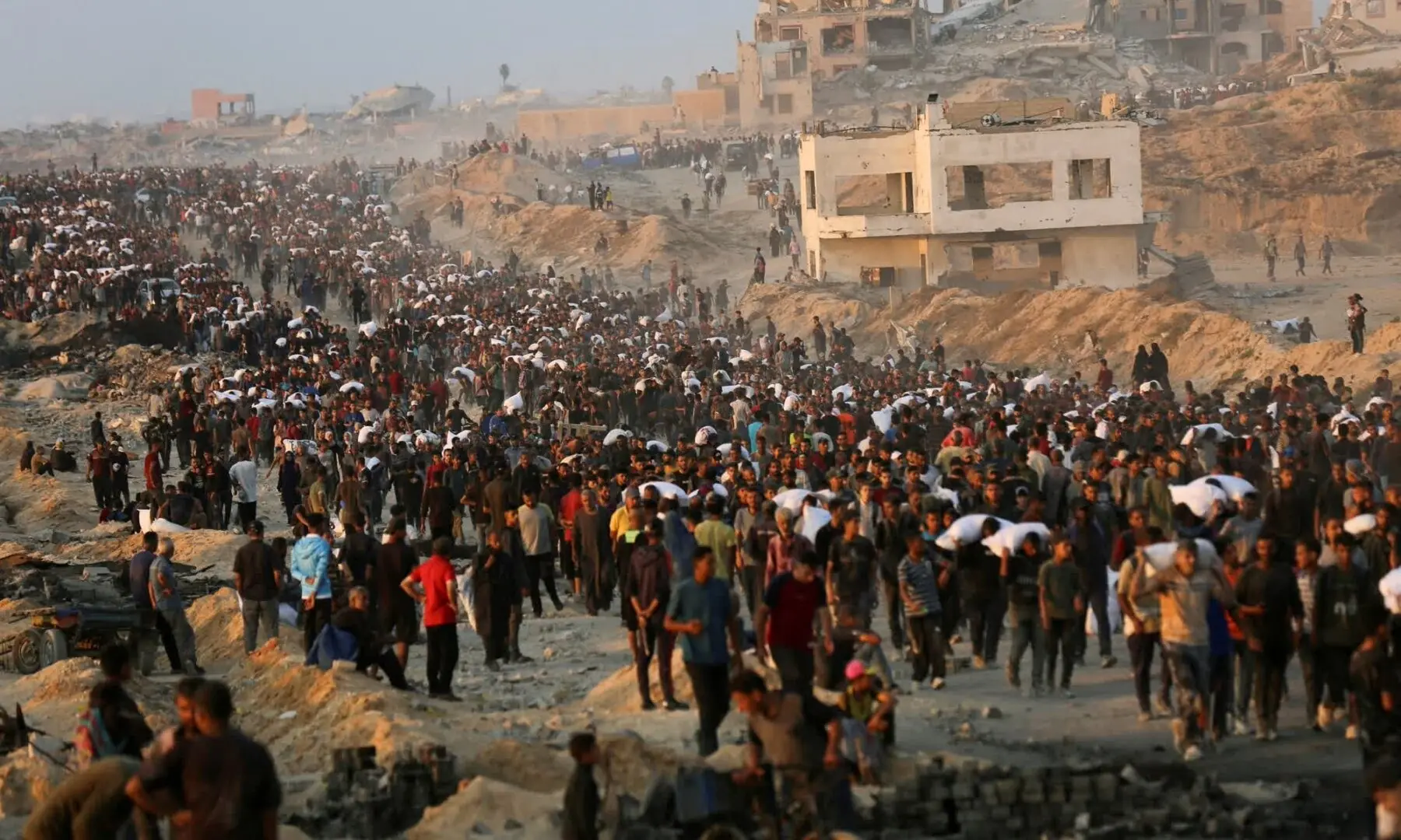   Palestinians gather for aid in Beit Lahia, Gaza, on June 17. — Reuters  