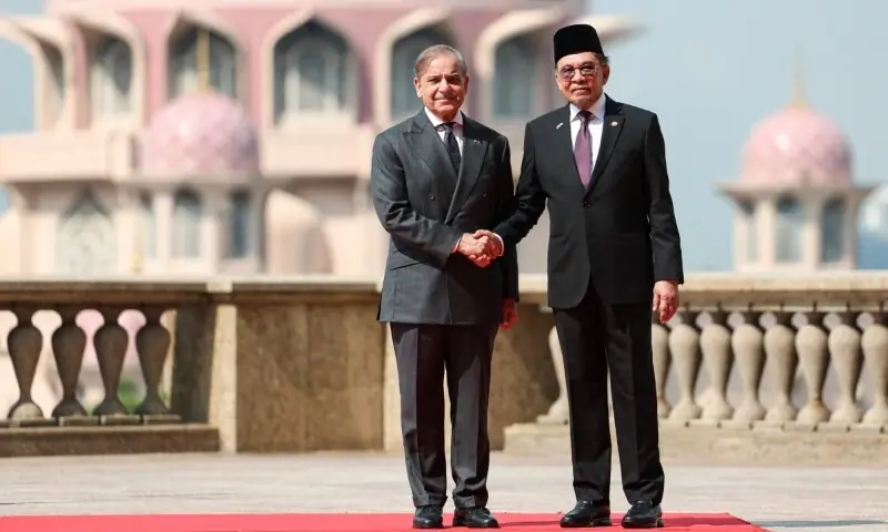 Prime Minister Shehbaz Sharif and Malaysia&rsquo;s Prime Minister Anwar Ibrahim shake hands during a meeting in Putrajaya on October 6. &mdash; AFP