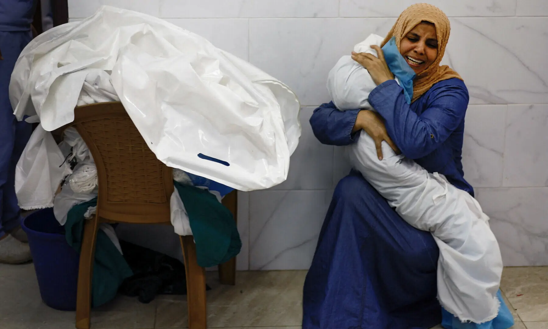 Inas Abu Maamar embraces the body of her 5-year-old niece Saly, who was killed in an Israeli strike, at Nasser hospital in Khan Younis in the southern Gaza Strip, October 17, 2023.&mdash;Reuters