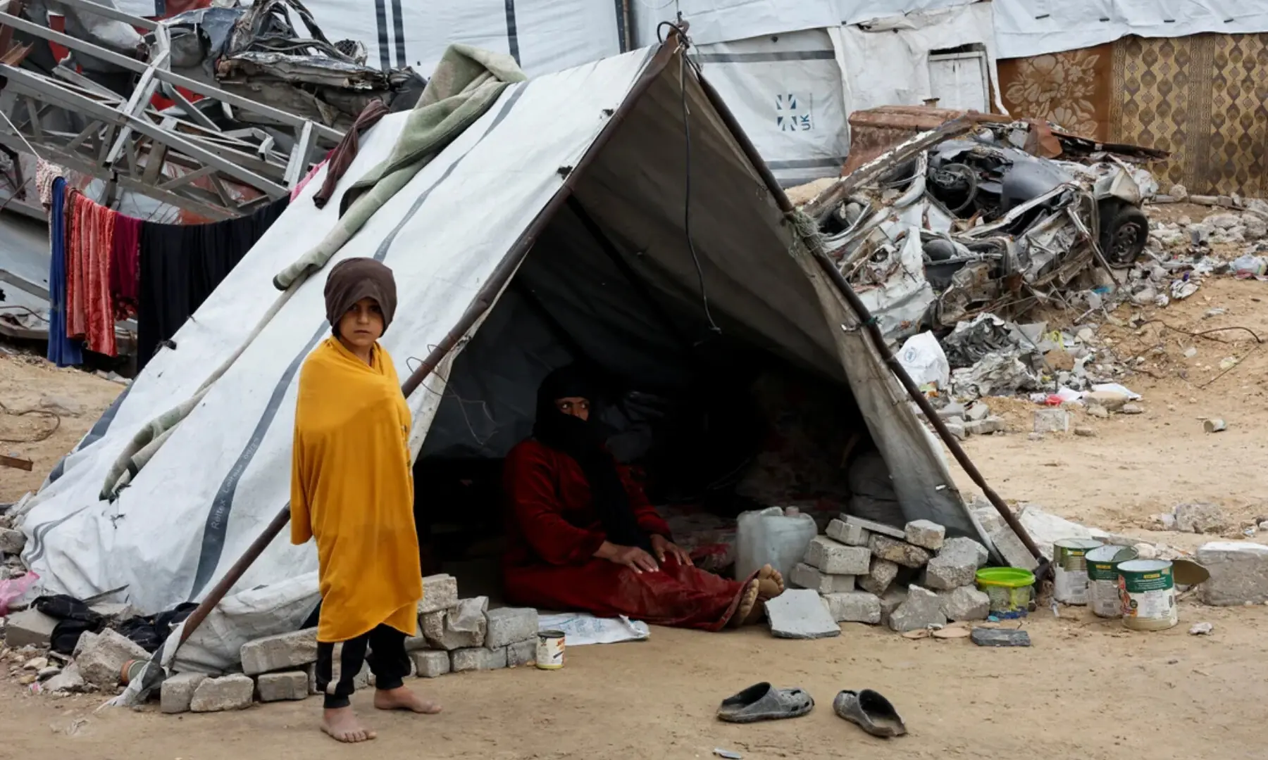  A displaced Palestinian child stands near a tent following rainfall in Gaza City on Nov 24, 2024. — Reuters 