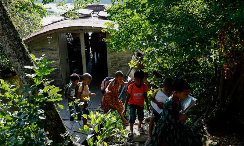 Students get off the boat-school, built by an NGO named Shidhulai Swanirvar Sangstha, after the class, in Bhangura area of Pabna, Bangladesh, on September 25. — Reuters