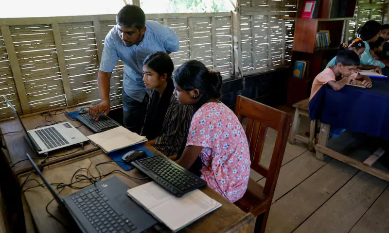 Young girls receive computer training in a floating library and training center, built on a boat by an NGO named Shidhulai Swanirvar Sangstha, in Bhangura area of Pabna, Bangladesh, on September 25. — Reuters