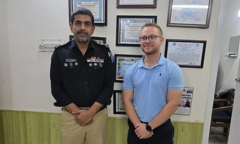 Airport Police Station House Officer Kaleem Khan Moosa with British police officer Duncan Verwey on Tuesday. &mdash; Karachi Police