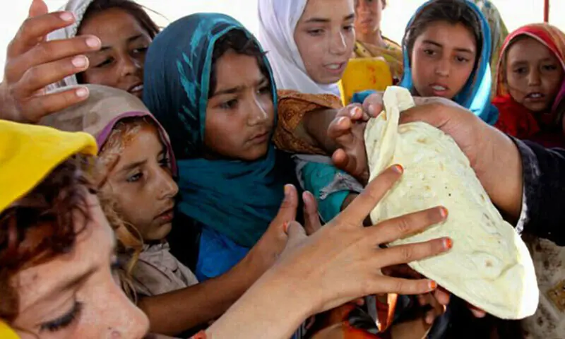 In this file photo, children crowd around a piece of bread. &mdash; AFP/File